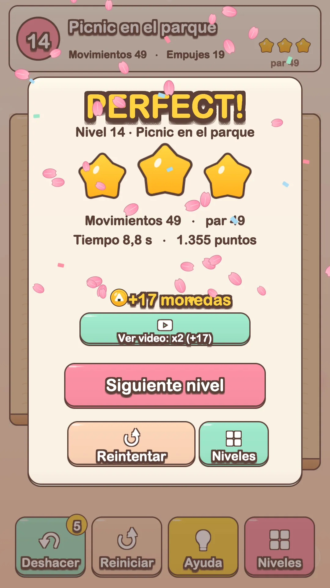 Victoria perfecta en Neko Bento: tres estrellas, los movimientos, el tiempo y el puntaje del nivel, con pétalos de sakura cayendo.